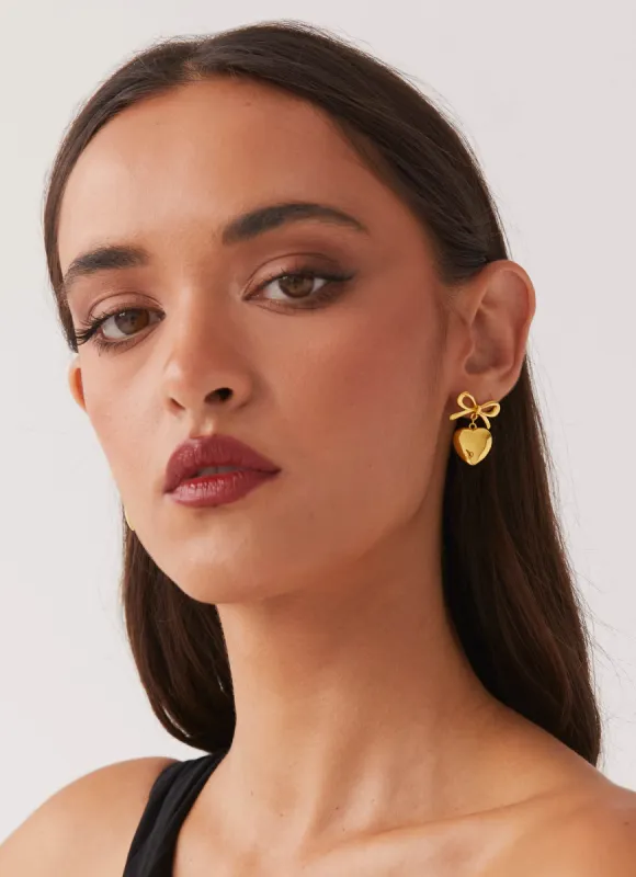 Chasity Bow And Heart Earrings - Gold sold by Peppermayo