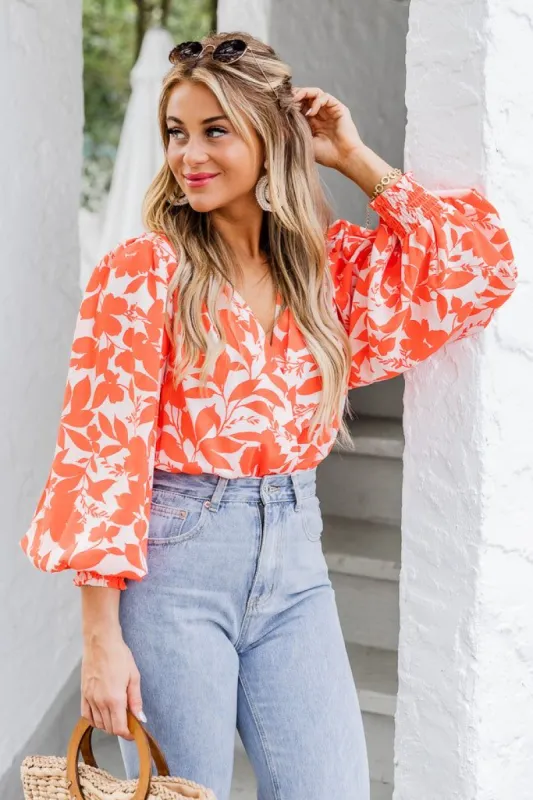 Having More Fun Floral Orange Long Sleeve Bodysuit sold by Pink Lily