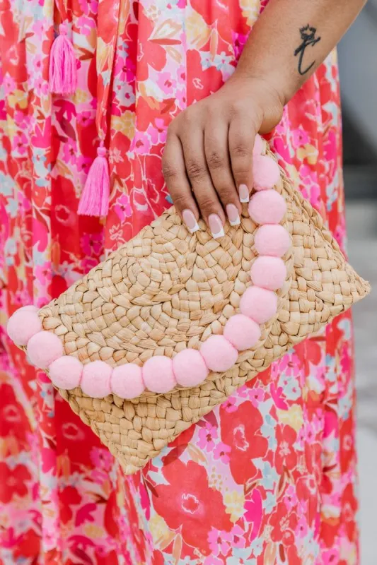 Pom Pomp and Circumstance Pink Pom Straw Clutch sold by Pink Lily