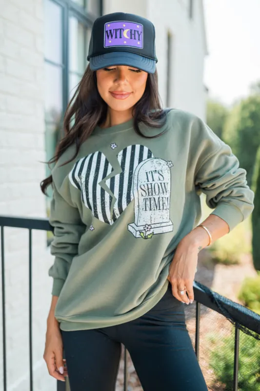 It's Showtime Olive Oversized Graphic Sweatshirt sold by Pink Lily