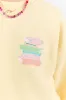 Can't Buy You Happiness But Can Buy Books Light Yellow Graphic Sweatshirt sold by Pink Lily