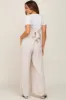 Beige Ruffle Trim Back Tie Maternity Jumpsuit sold by Pinkblush