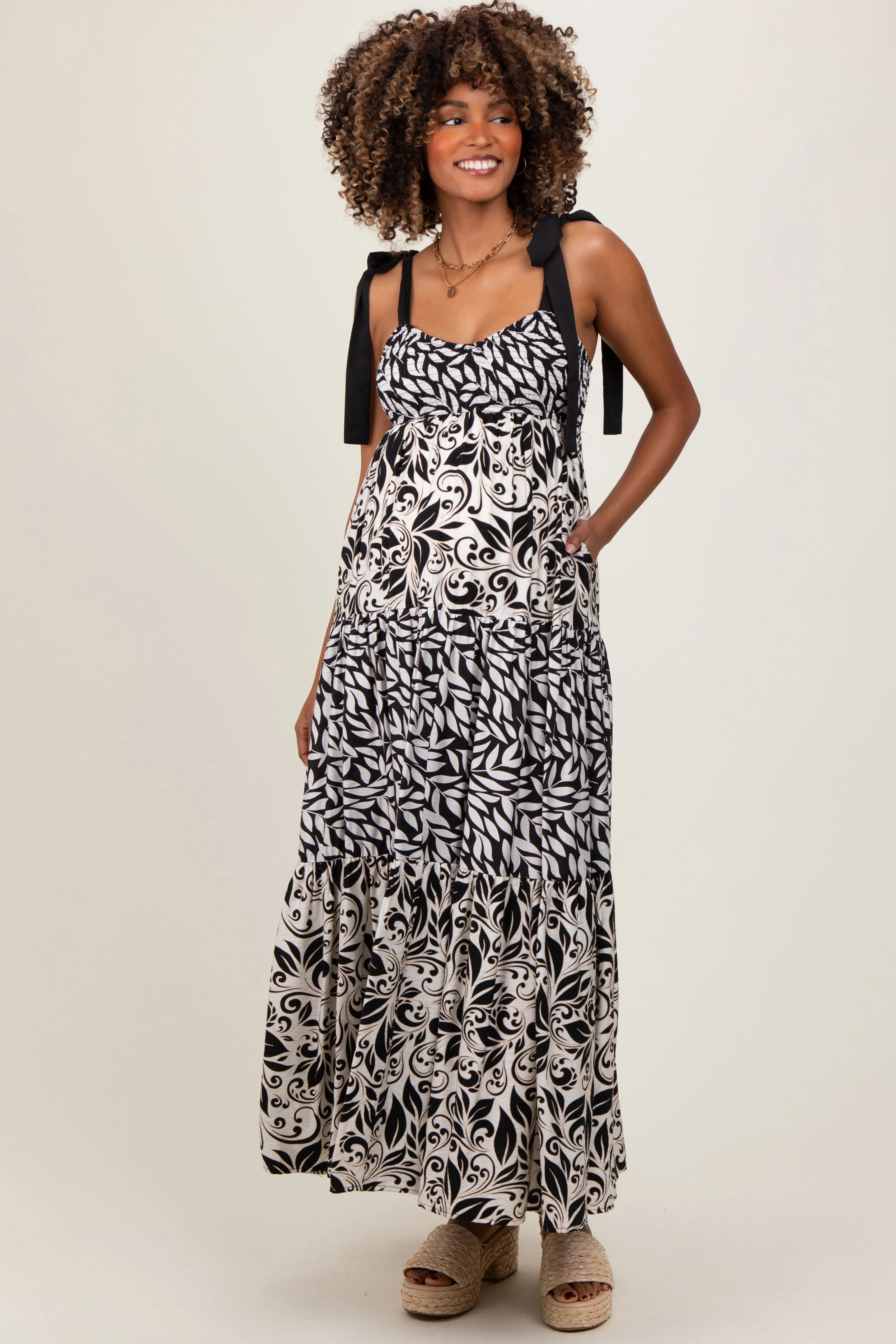 Black Leaf Print Smocked Shoulder Tie Tiered Maternity Maxi Dress sold by Pinkblush