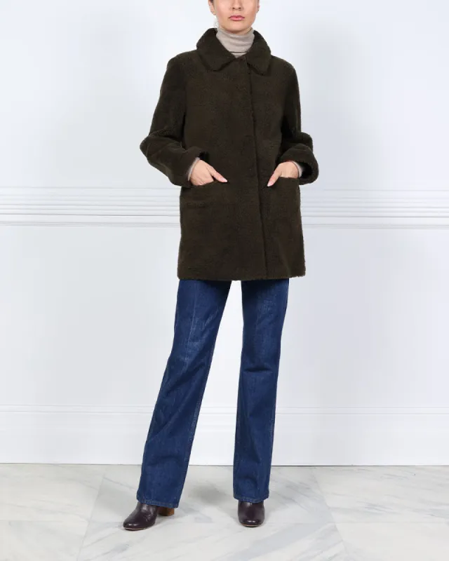 The Stasia Reversible Patent Shearling Jacket in Olive sold by Pologeorgis