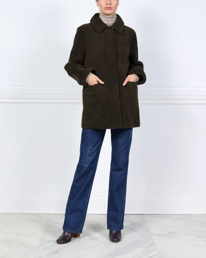 The Stasia Reversible Patent Shearling Jacket in Olive sold by Pologeorgis