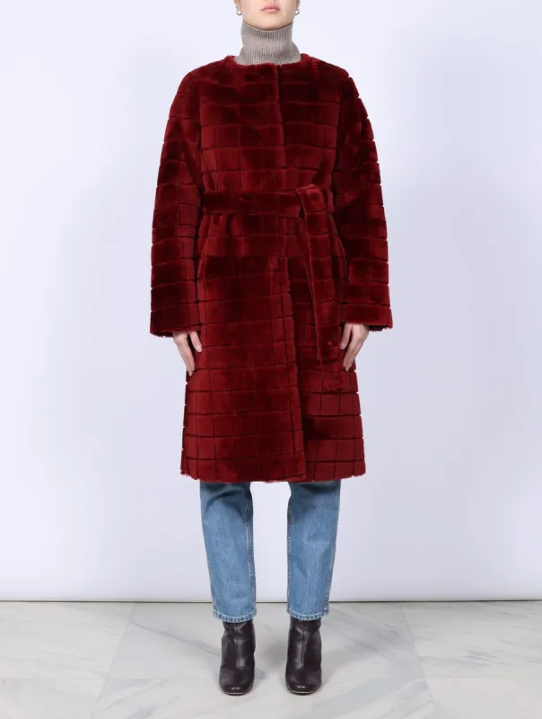 The Garnet Belted Shearling Coat sold by Pologeorgis