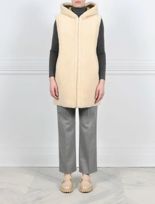 The Lyra Hooded Shearling Reversible Puffer Vest sold by Pologeorgis