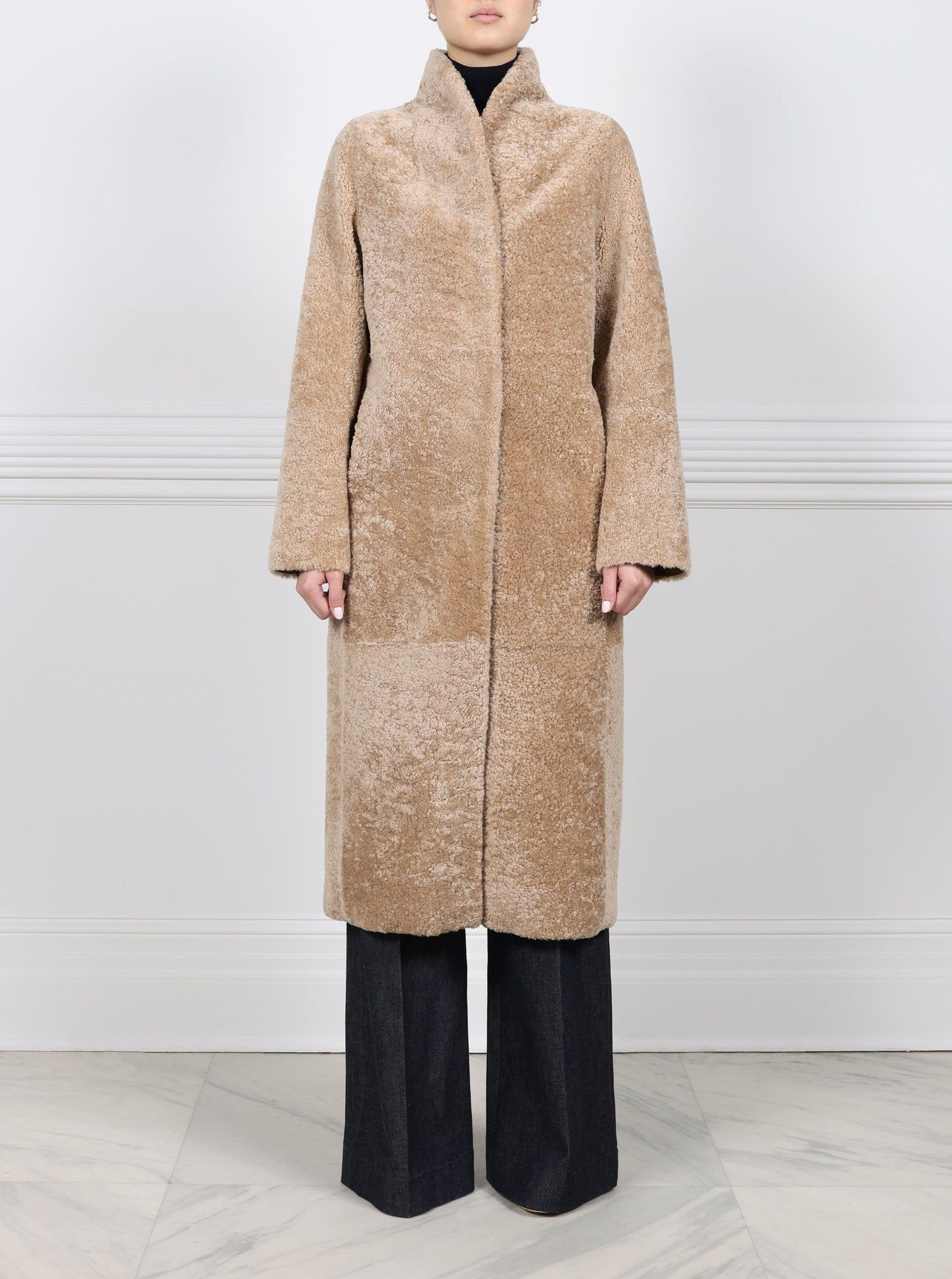 The Cleo Reversible Curly Shearling Coat in Tan sold by Pologeorgis
