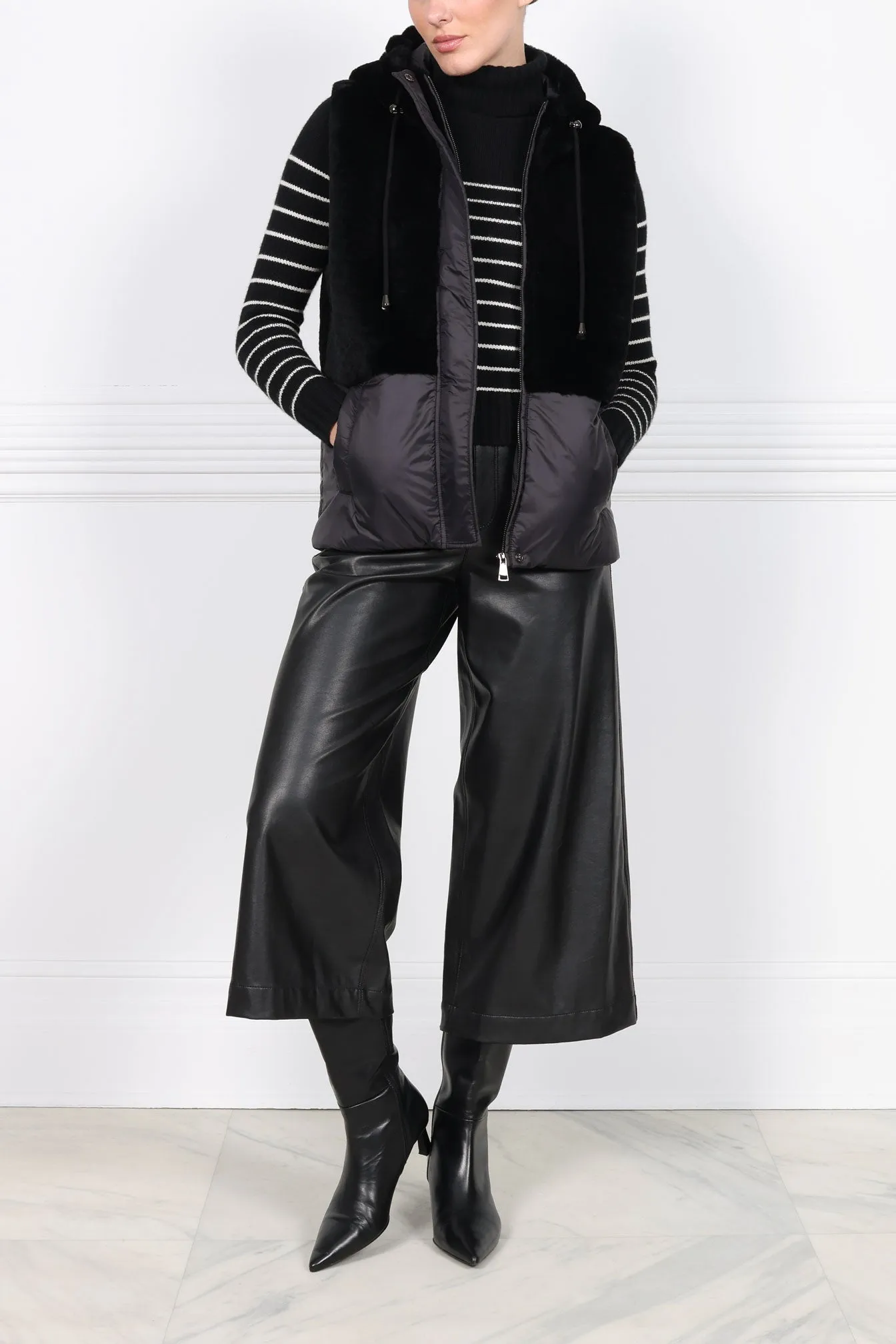 The BC Hooded Shearling Puffer Vest sold by Pologeorgis