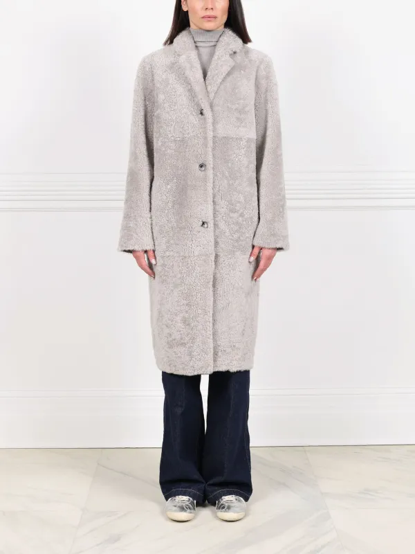 The Landen Button Down Curly Shearling Coat sold by Pologeorgis