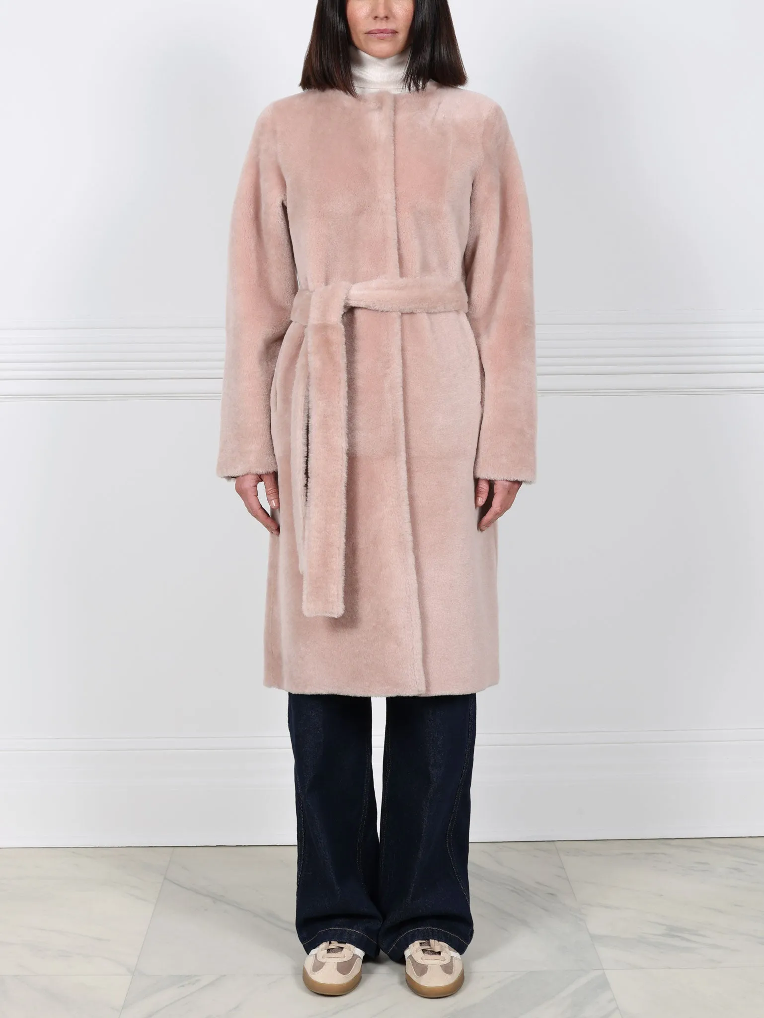 The Marilyn Reversible Belted Shearling Coat sold by Pologeorgis