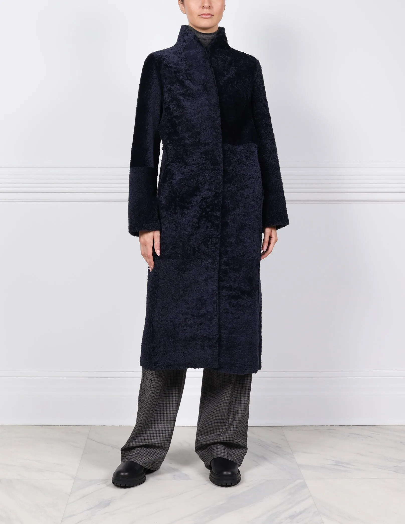 The Cleo Curly Shearling Coat sold by Pologeorgis