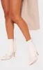 Cream Wide Fit Faux Leather Point Toe Buckle Detail Tab Ankle Heeled Boots sold by Pretty Little Thing