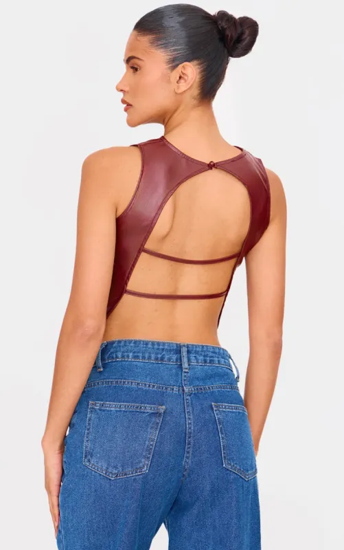 Chocolate Faux Leather Back Strap Crop Top sold by Pretty Little Thing