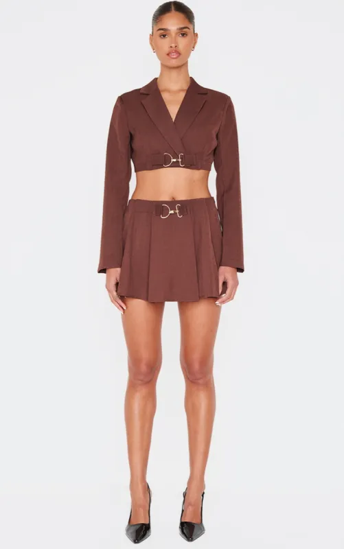 Chocolate Tailored Woven Buckle Detail Pleated Micro Mini Skirt sold by Pretty Little Thing