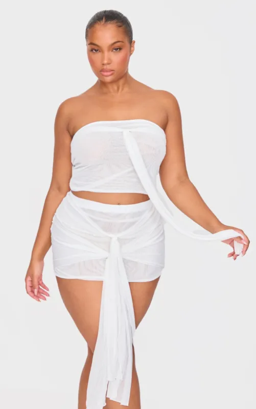 Premium White Double Layer Mesh Ruched Knot Detail Mini Skirt sold by Pretty Little Thing