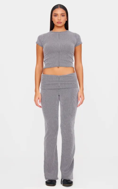 Charcoal Grey Two Tone Crinkle Rib Foldover Skinny Flared Trousers sold by Pretty Little Thing