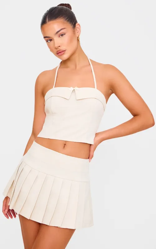 Cream Bow Detail Tie Neck Halterneck Crop Top sold by Pretty Little Thing