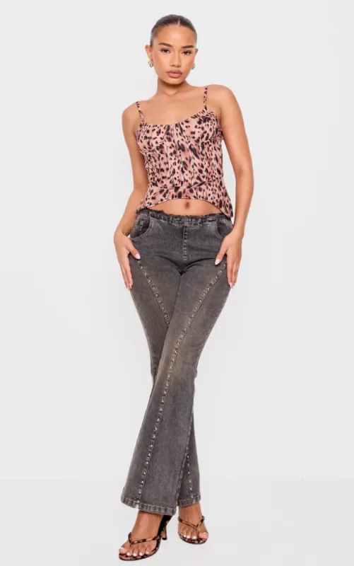 Petite Washed Black Stud Detail Denim Flared Jeans sold by Pretty Little Thing