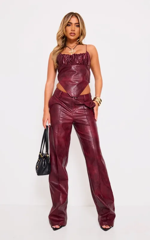Burgundy Washed Faux Leather Dip Waist Flared Trousers sold by Pretty Little Thing