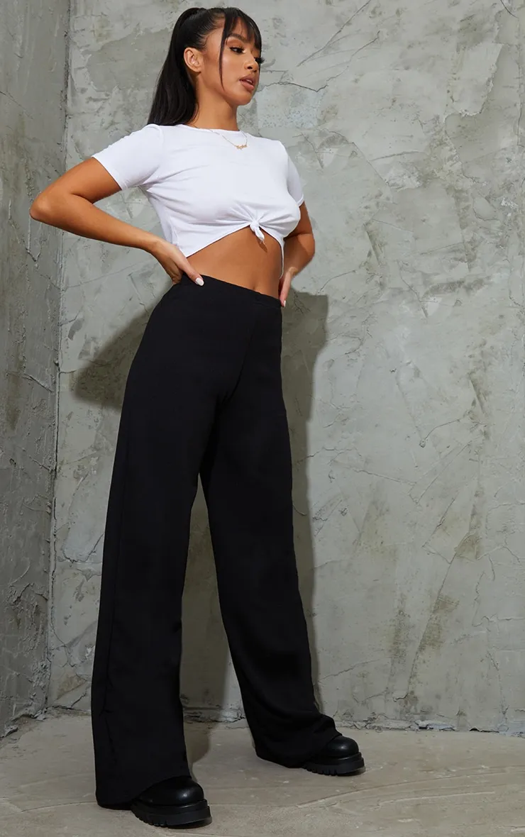 Petite Black Wide Leg Trousers sold by Pretty Little Thing