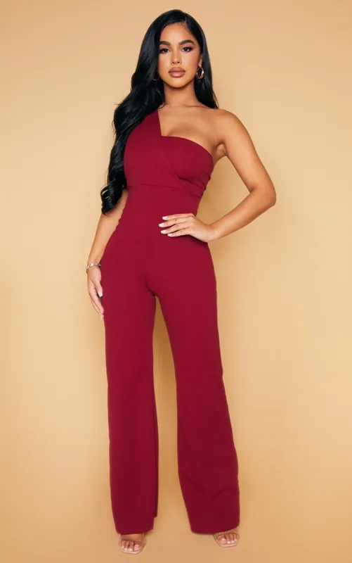 Petite Burgundy Drape One Shoulder Jumpsuit sold by Pretty Little Thing