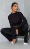 Black High Neck Long Sleeve Crop Top sold by Pretty Little Thing