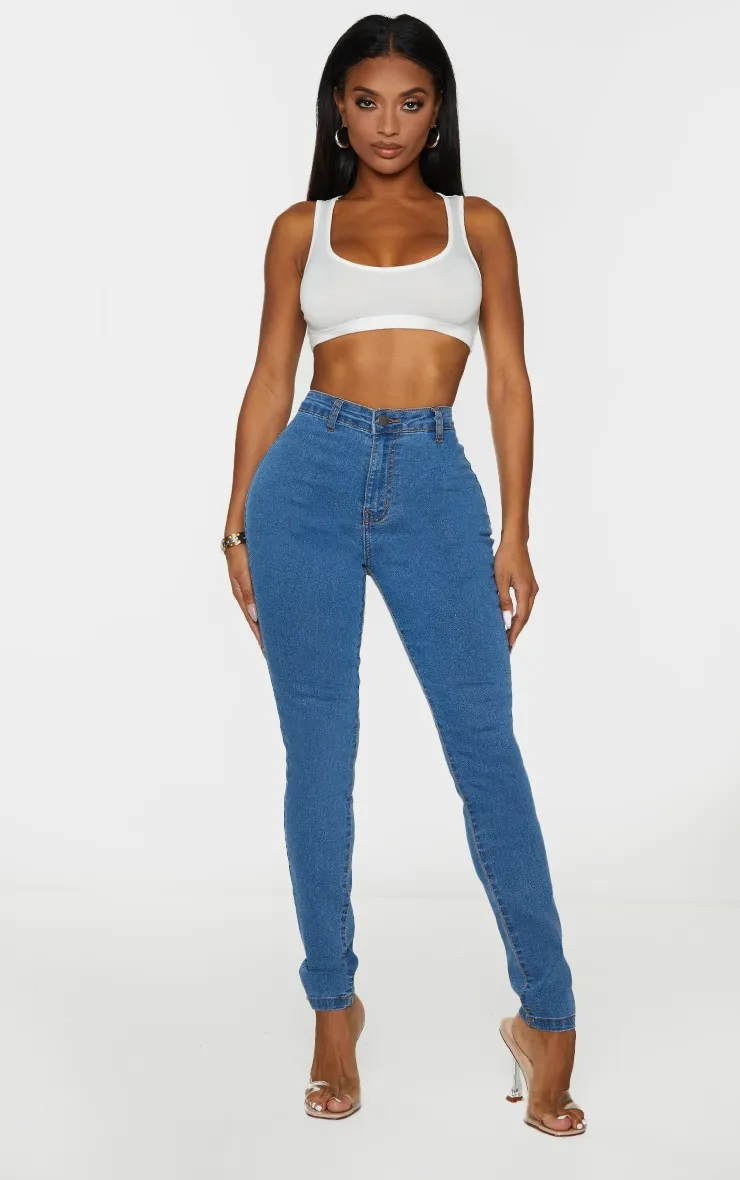 Shape Mid Wash Disco Skinny Jeans sold by Pretty Little Thing