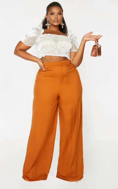 Plus Rust Pleat Detail Wide Leg Trousers sold by Pretty Little Thing