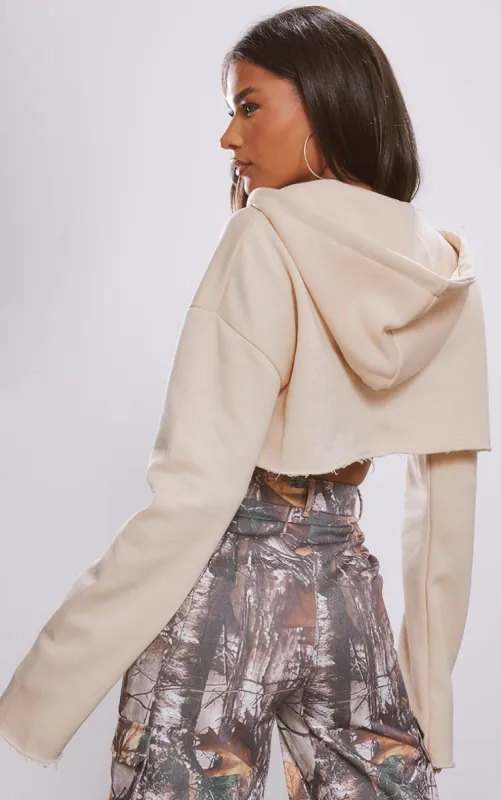 Cream V Neck Raw Hem Cropped Hoodie sold by Pretty Little Thing