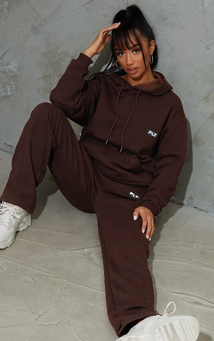 PRETTYLITTLETHING Petite Chocolate Badge Detail Straight Leg Joggers sold by Pretty Little Thing