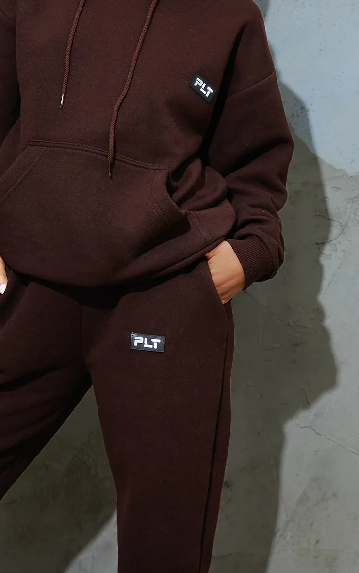 PRETTYLITTLETHING Petite Chocolate Badge Detail Straight Leg Joggers sold by Pretty Little Thing product image thumbnail 4