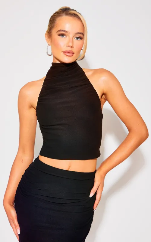 Black Soft Touch Ruched Halterneck Crop Top sold by Pretty Little Thing