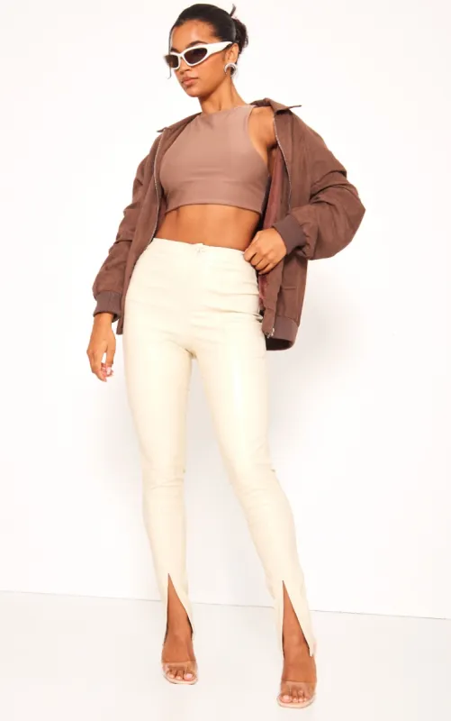Cream Split Hem Faux Leather Skinny Trousers sold by Pretty Little Thing