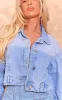 Mid Blue Wash Upside Down Waistband Crop Denim Jacket sold by Pretty Little Thing