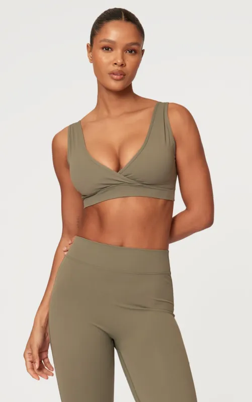 Olive Sculpt Cross Front Sports Bra sold by Pretty Little Thing