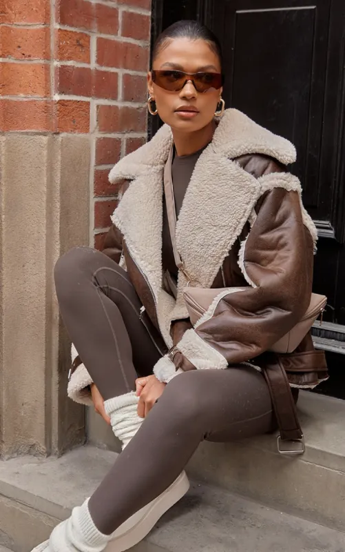 Brown Borg Trim Belted Hem Faux Leather Aviator Jacket sold by Pretty Little Thing