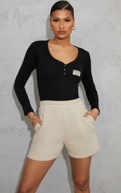 PRETTYLITTLETHING Black Thick Rib Badge Detail Button Front Bodysuit sold by Pretty Little Thing