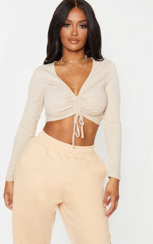 Shape Sand Ribbed Long Sleeve Ruched Front Crop Top sold by Pretty Little Thing