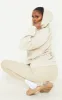 PRETTYLITTLETHING Sand Embroidered Slogan Pocket Hoodie sold by Pretty Little Thing