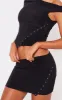 Black Slinky Low Rise Slit Hem Eyelet Detail Micro Mini Skirt sold by Pretty Little Thing