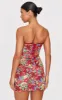 Burgundy Tapestry Bandeau Lace Up Back Bodycon Dress sold by Pretty Little Thing