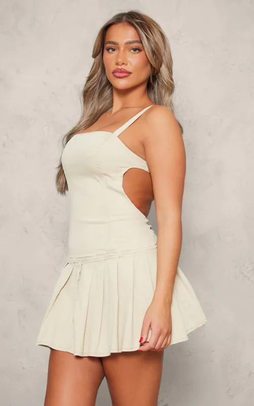 Washed Stone Cut Out Side Pleated Denim Mini Dress sold by Pretty Little Thing