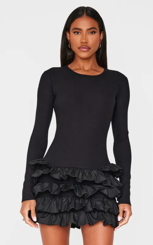 Black Ribbed Long Sleeve Frill Mini Dress sold by Pretty Little Thing