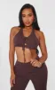 Shape Brown Denim Halterneck Lace Up Front Crop Top sold by Pretty Little Thing