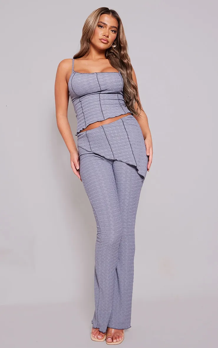 Charcoal Textured Asymmetric Flare Trousers sold by Pretty Little Thing