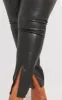 Plus Black Split Hem Faux Leather Skinny Trousers sold by Pretty Little Thing