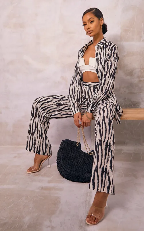 Black Zebra Print Wide Leg Trousers sold by Pretty Little Thing