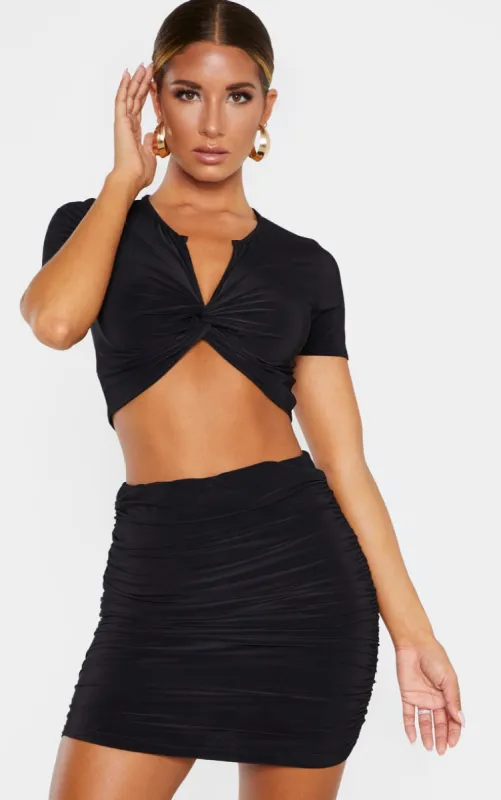 Black Slinky Twist Front Short Sleeve Crop Top sold by Pretty Little Thing
