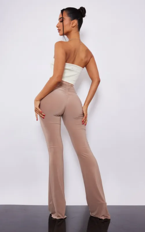  Petite Stone Slinky Ruched Bum Flare Trousers sold by Pretty Little Thing